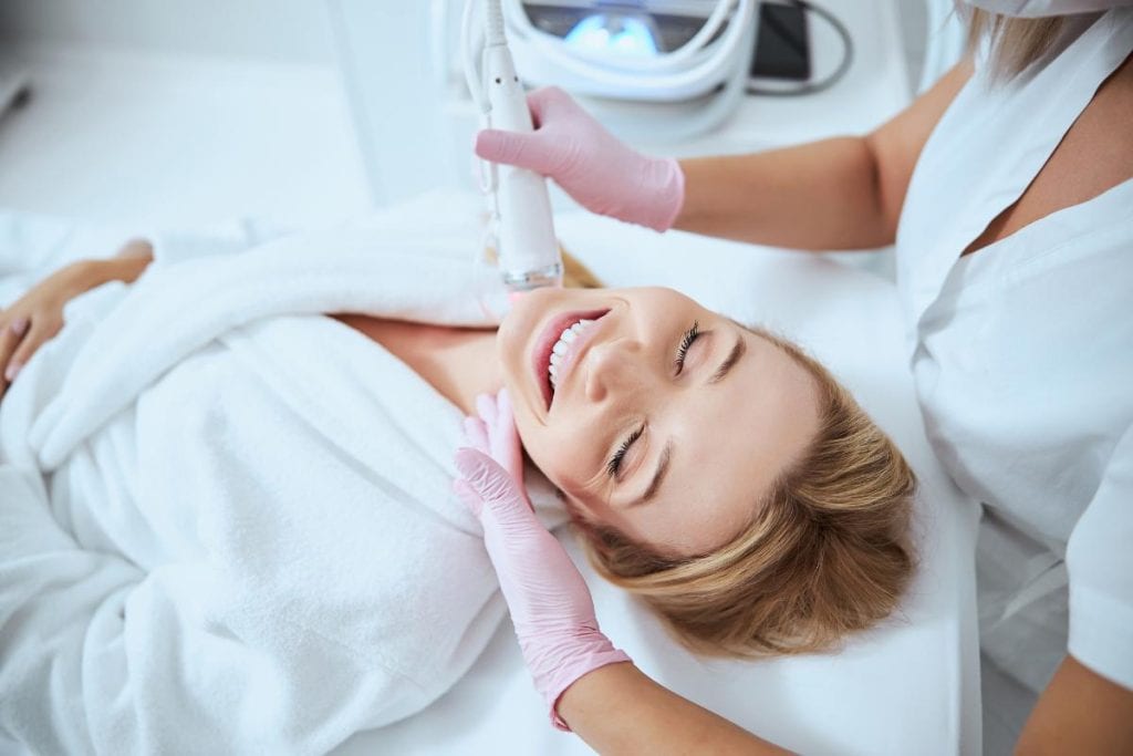 woman getting microneedling treatment