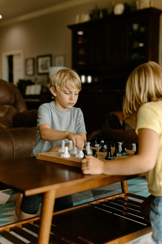 boy and girl playing chess