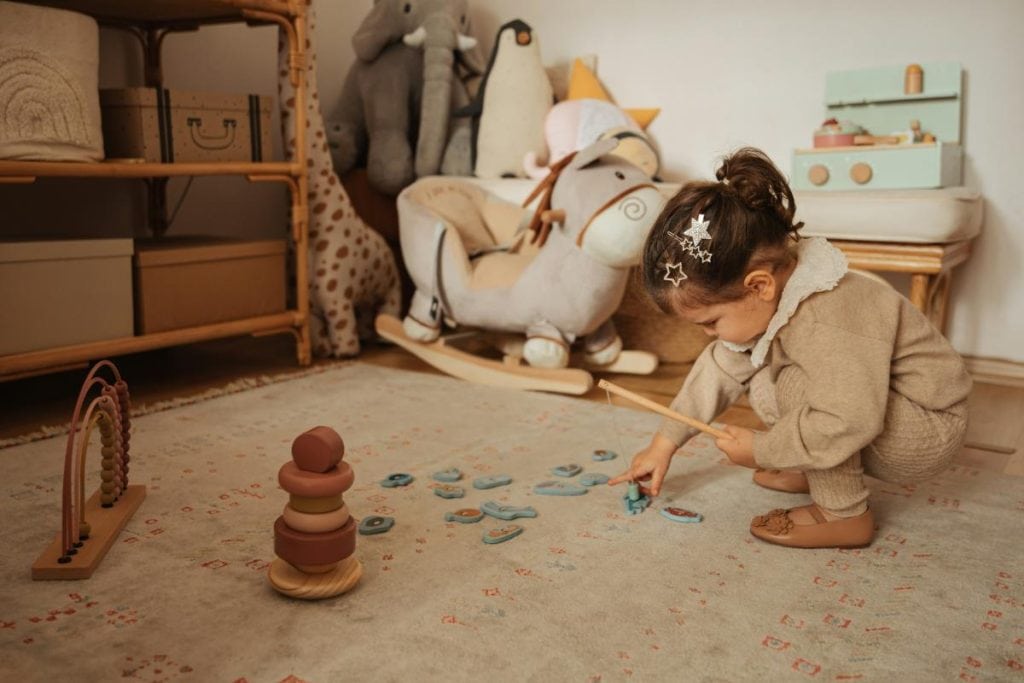 little girl playing games in playroom