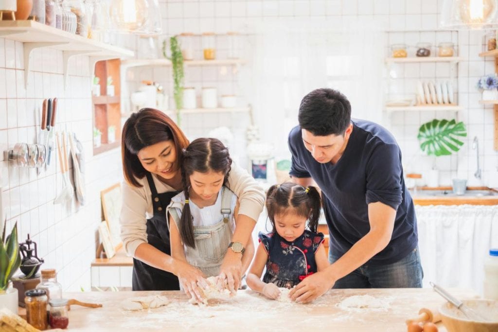 parents teaching children to cook