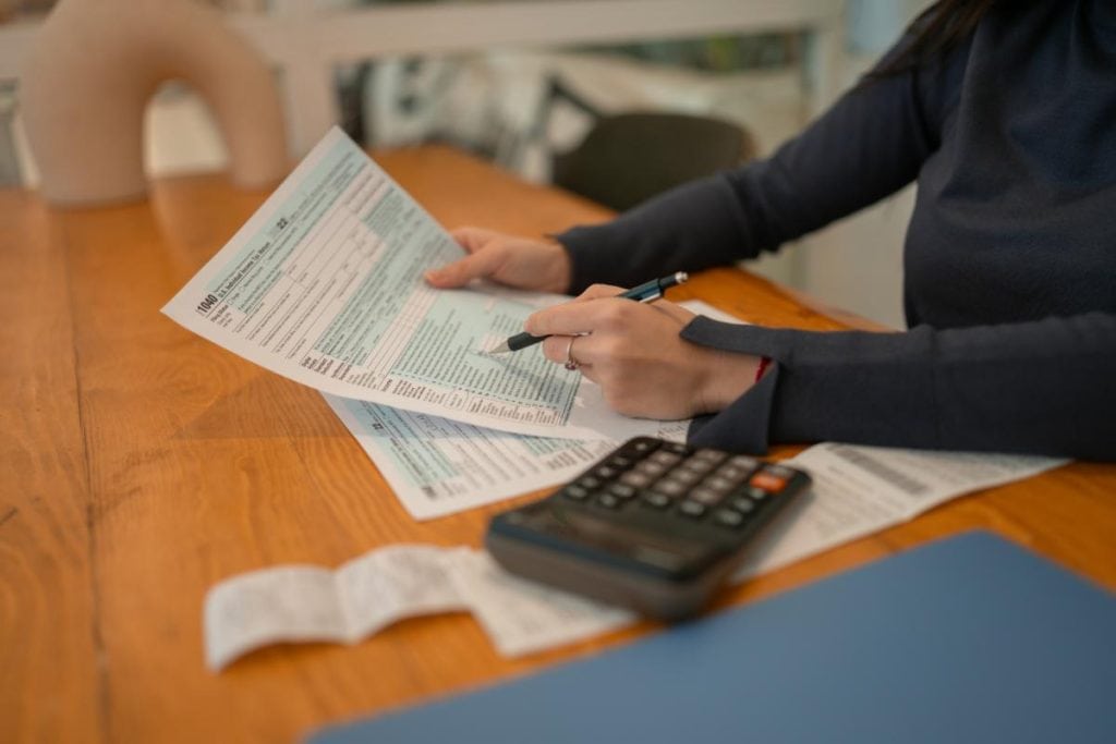 woman reviewing financial documents like a 1040