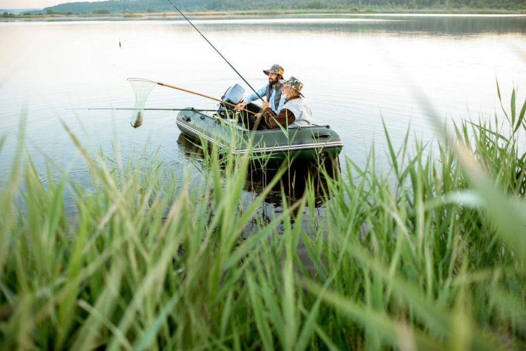 men fishing in a small boat