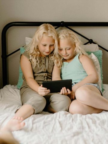 two young girls using a tablet