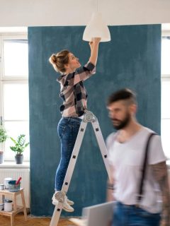 woman installing light bulb