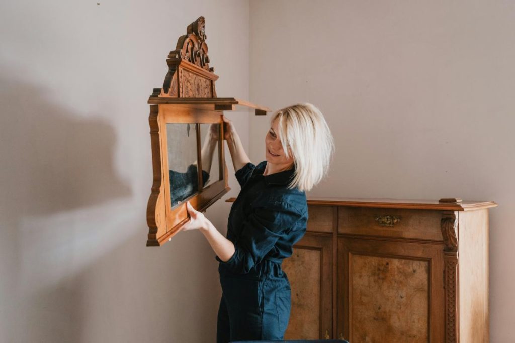 woman hanging a mirror