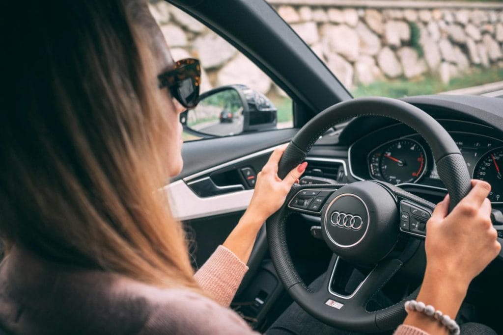 woman with hands on steering wheel of an Audi