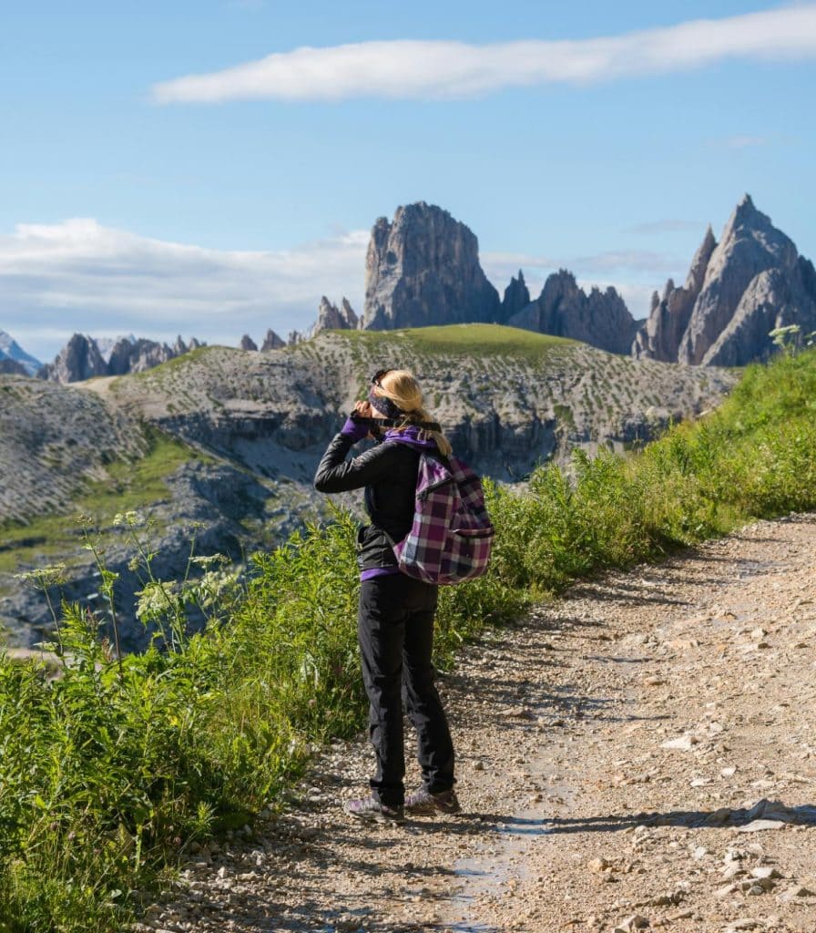 woman with backpack hiking in the mountains