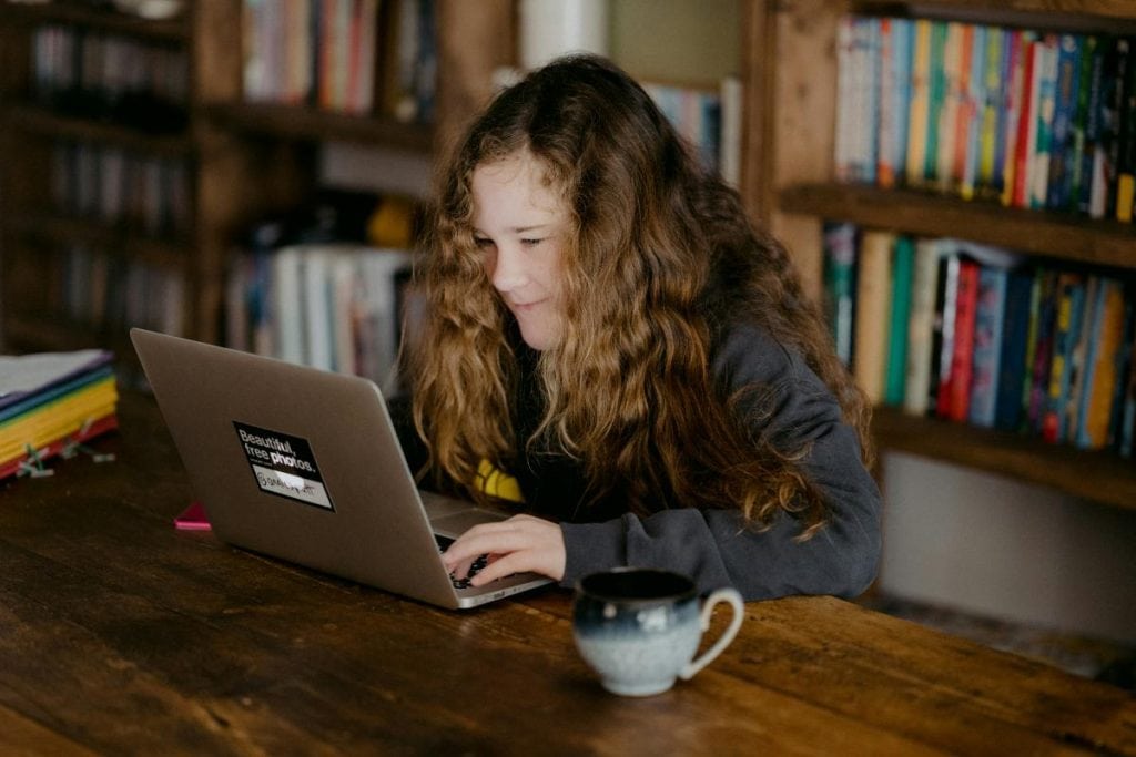 young woman using a laptop in a library