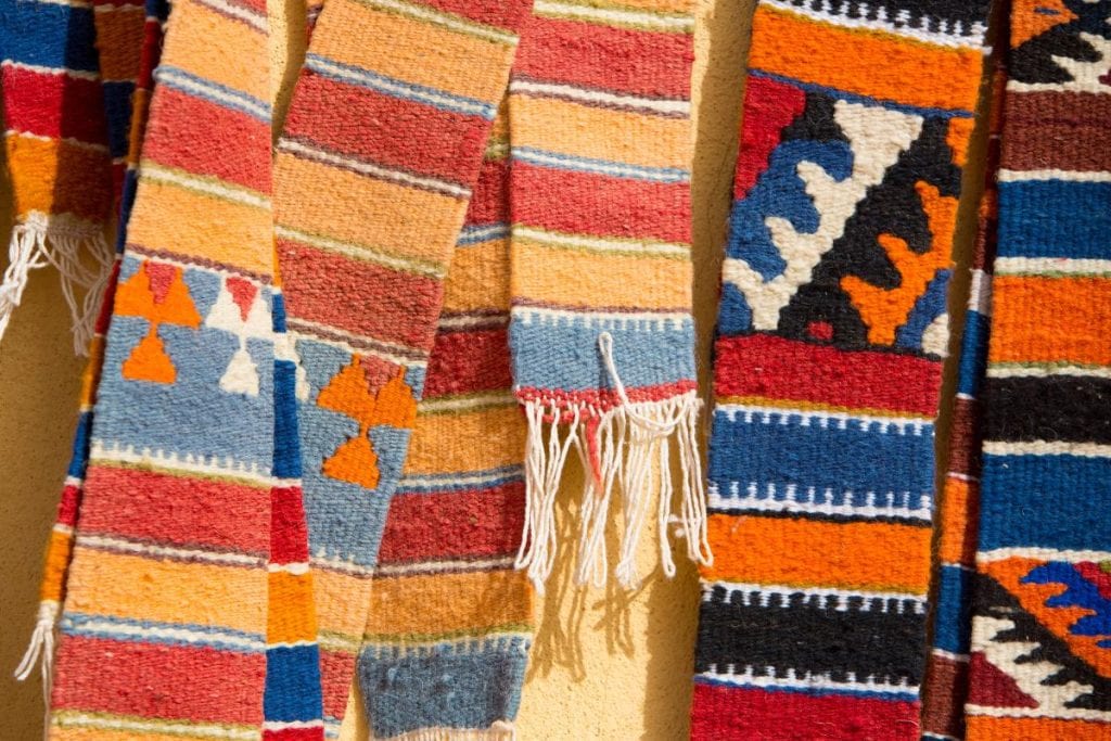 moroccan berber rugs hanging in a marketplace