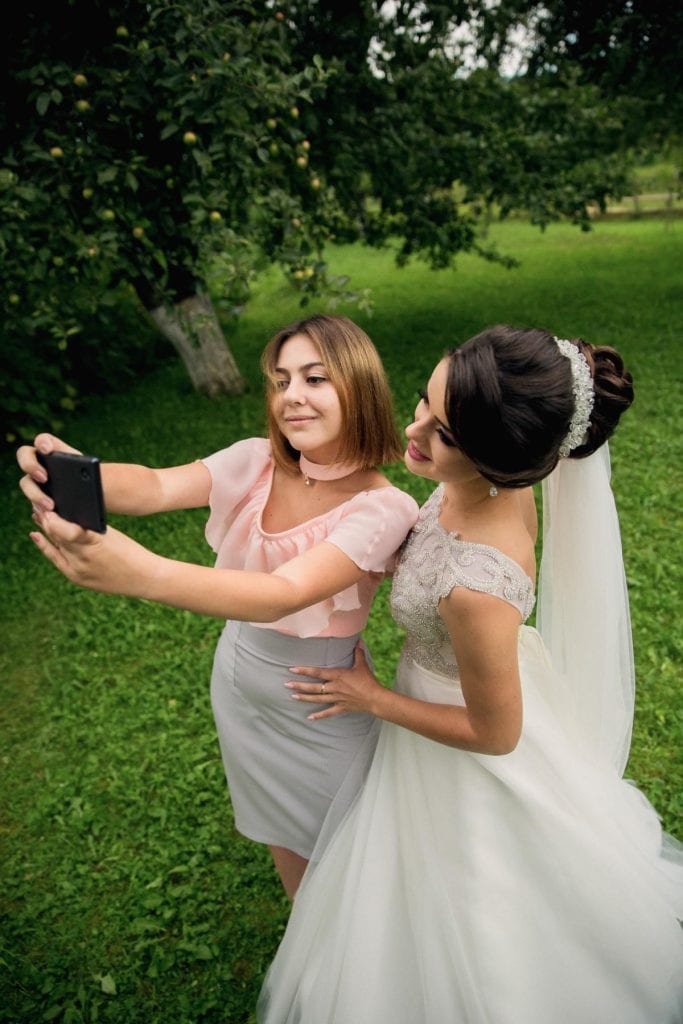 bridesmaid and bride taking a selfie