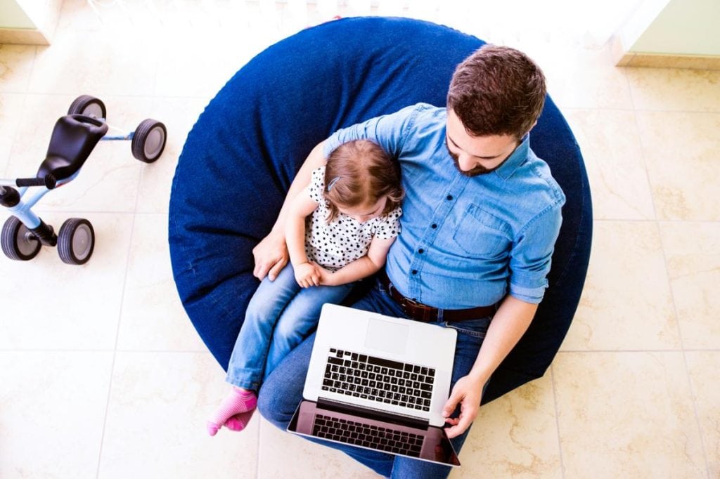 father and daughter sitting in a bean bag chair