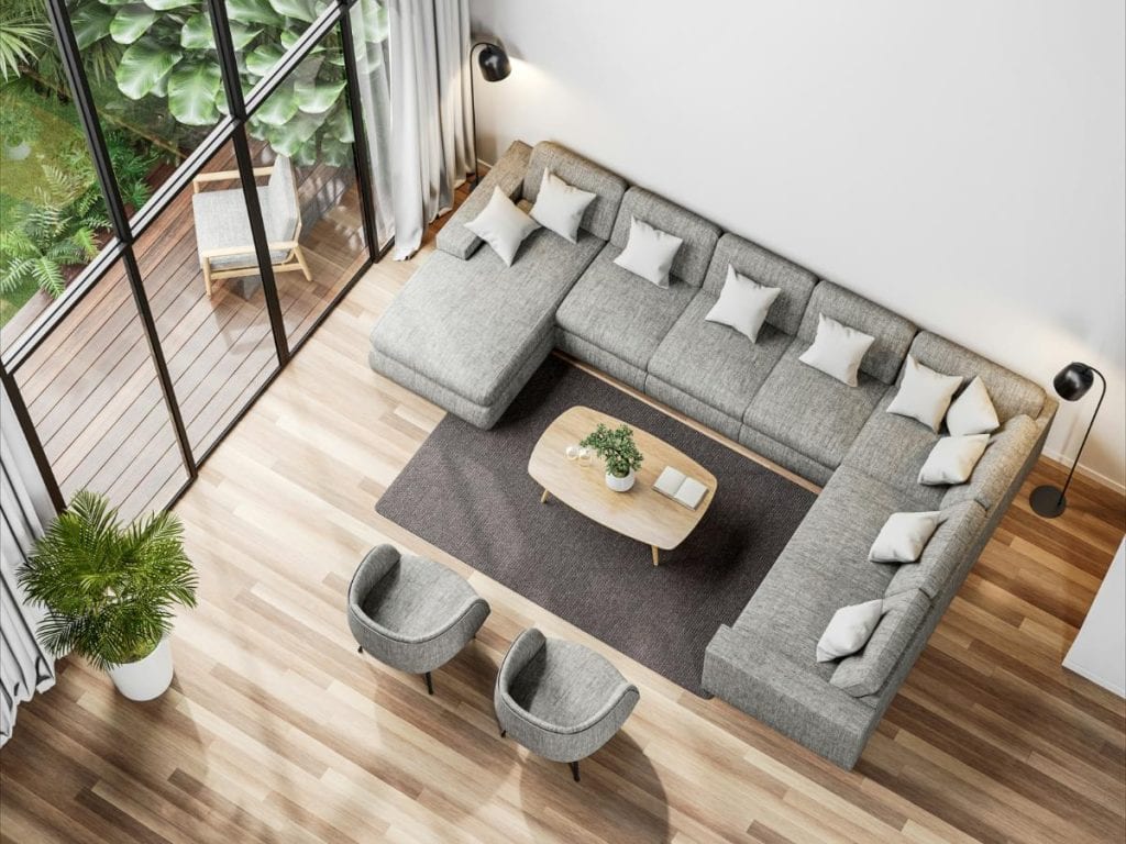 overhead view of gray modular sofa and modern chairs in living room