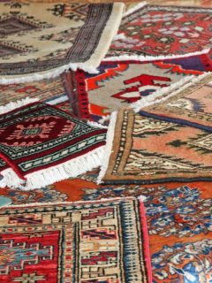 various handmade rugs strewn about on the floor