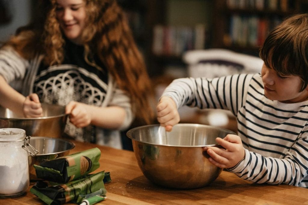 preteens making food - mixing ingredients in mixing bowls