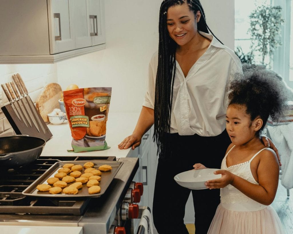 mom and daughter making chicken nuggets