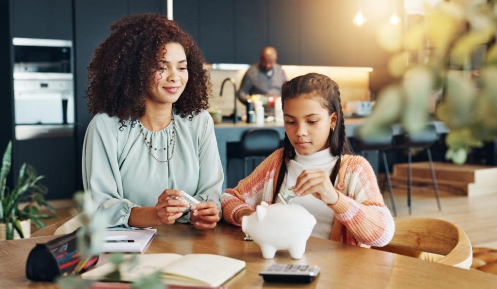 mom and daughter with piggy bank