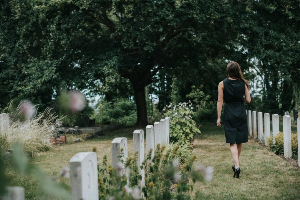 woman walking through peaceful cemetery