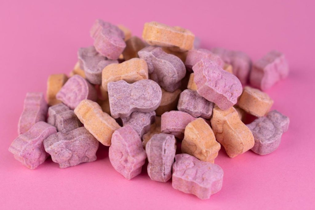 pile of kids vitamins on pink background