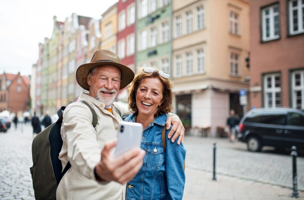 senior couple as tourists taking a selfie