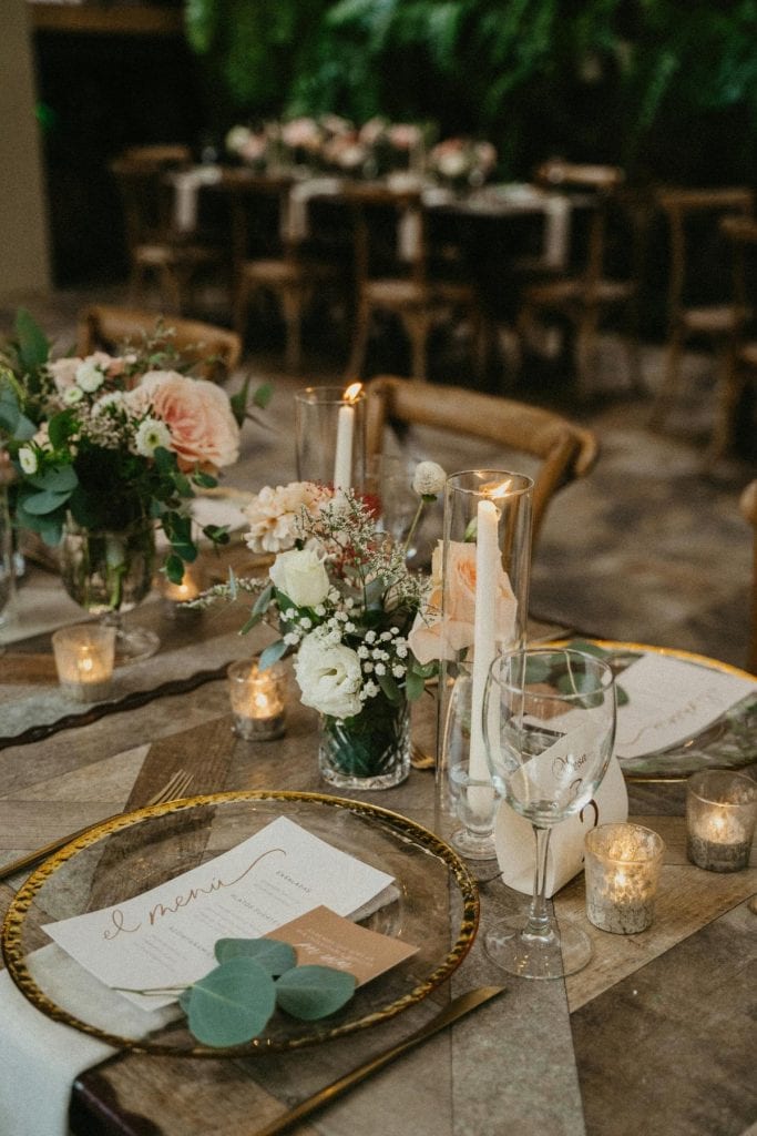 wedding table setting with flowers and lit candles