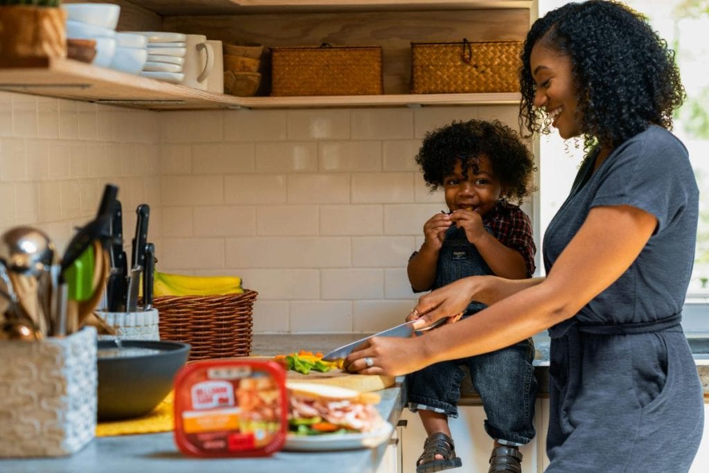 mother and child prepping sandwiches