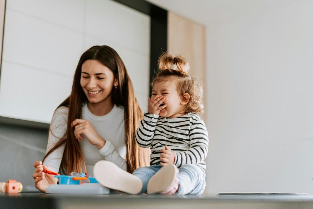 nanny laughing with toddler