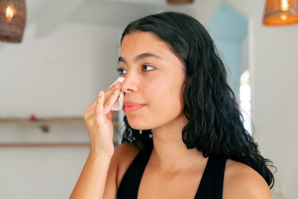 woman cleansing her face