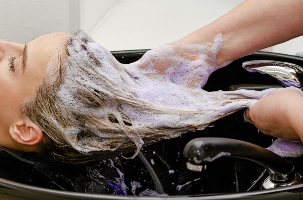 woman getting hair washed at a salon