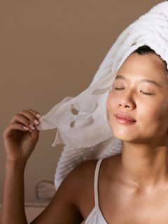 woman peeling mask off face