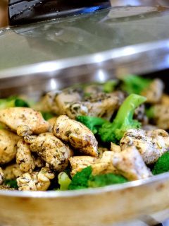 cooking chicken and broccoli in a pan