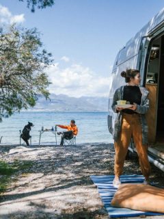 couple RV camping by a lake