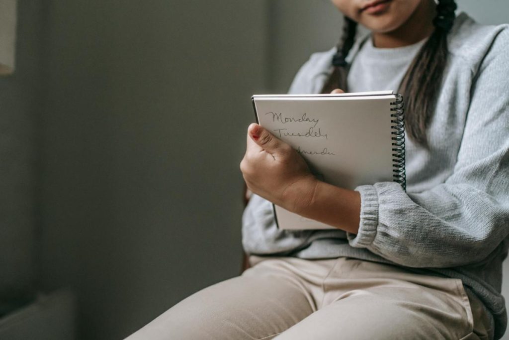 girl writing in journal