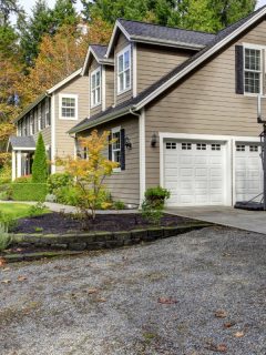 large house with three car garage with white garage doors