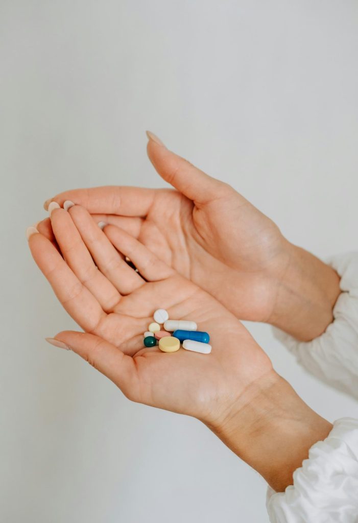 woman holding vitamins in her hands