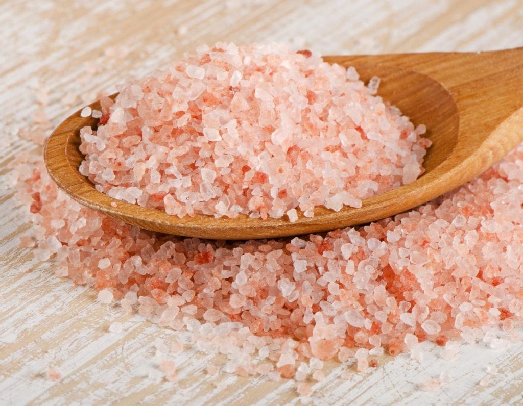 pink Himalayan salt on a wooden spoon