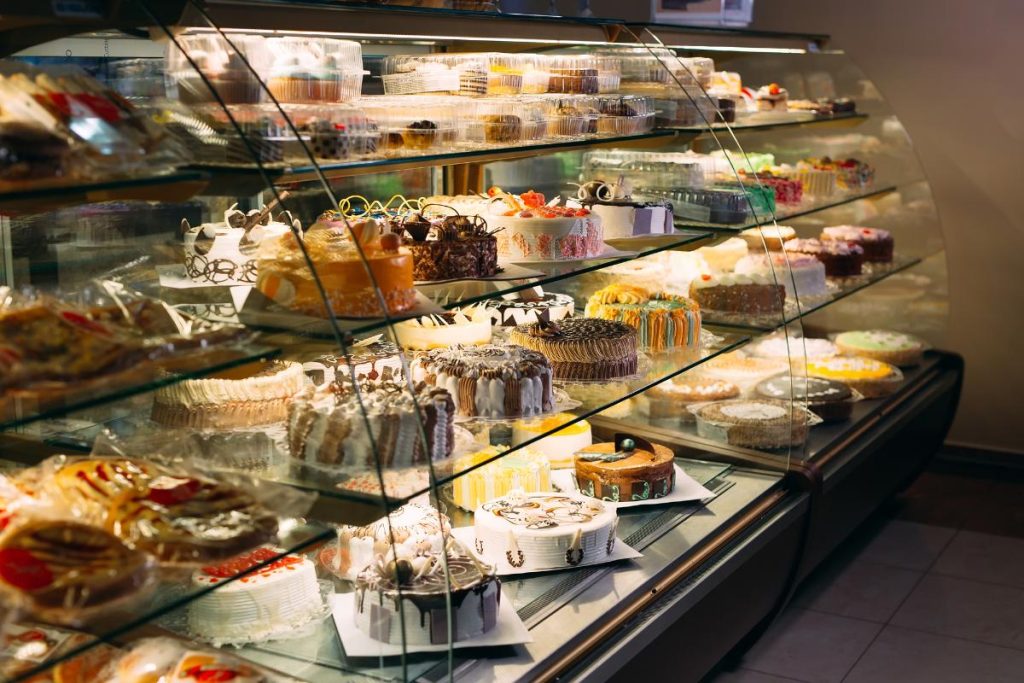 bakery case with cakes and desserts