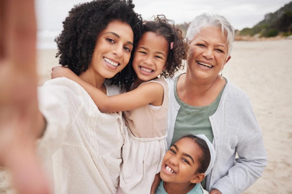 mom, daughters, and grandmother on the beach