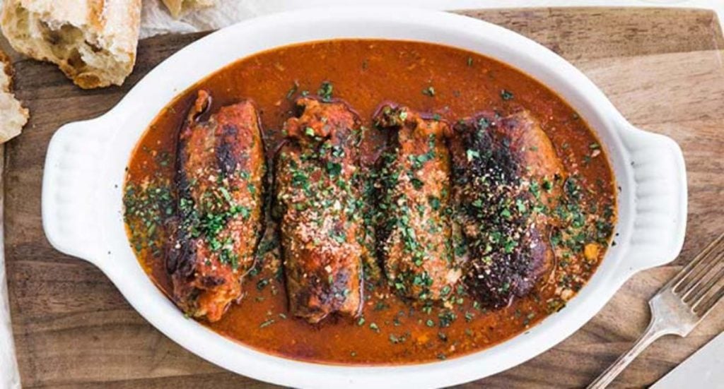 beef braciole in white casserole dish