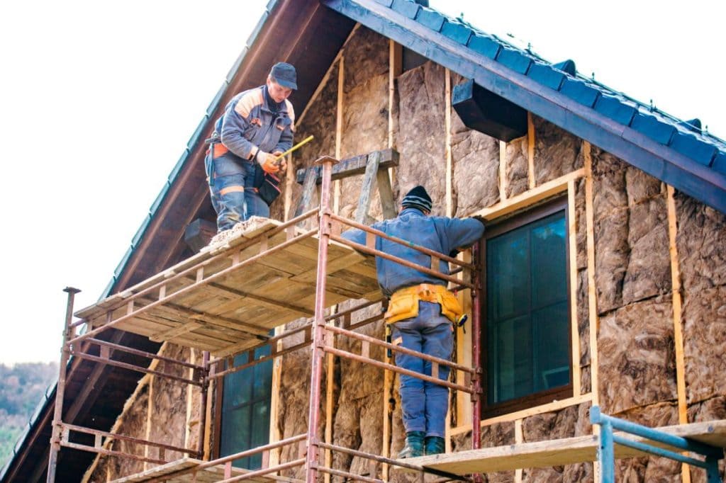 men on scaffolding working on a home