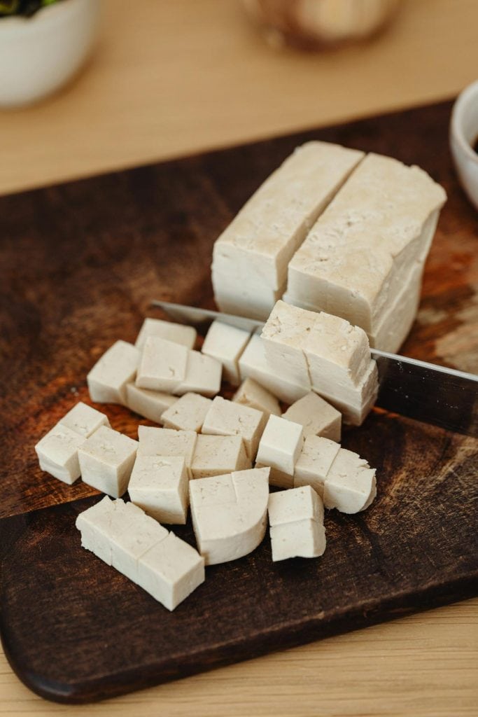 cubing tofu on a cutting board