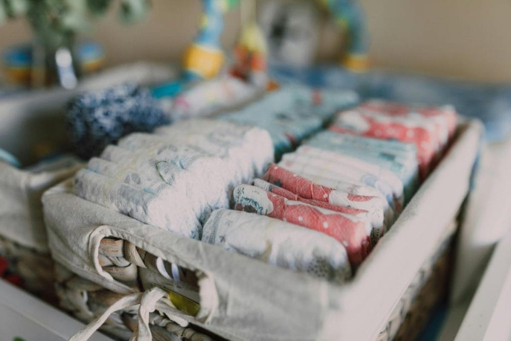 diapers organized neatly in bins in baby's room