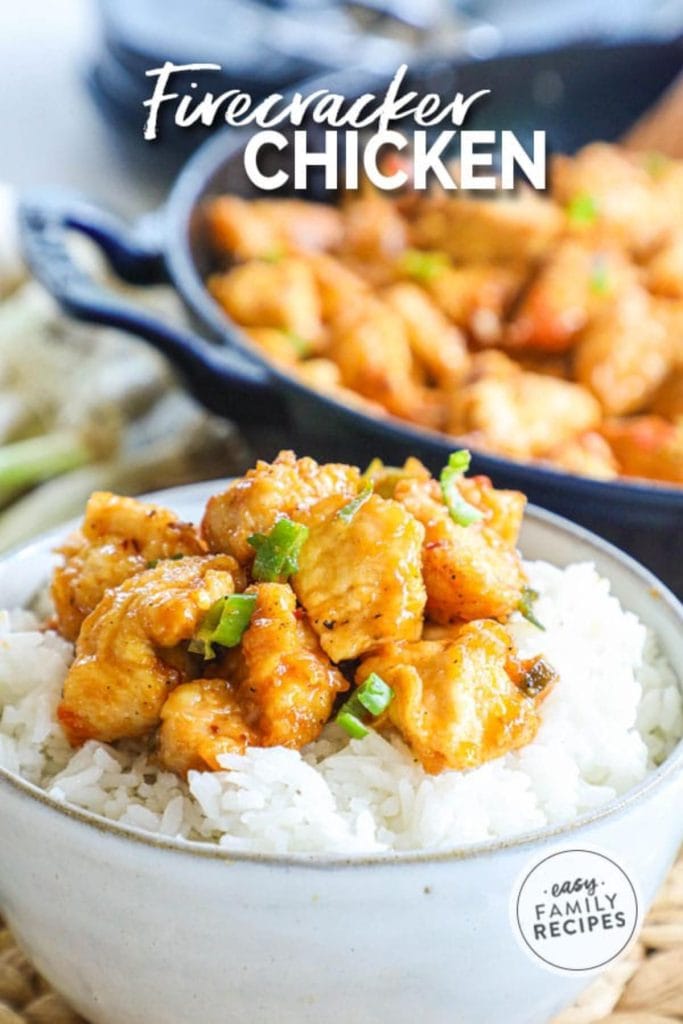 firecracker chicken over rice in white bowl