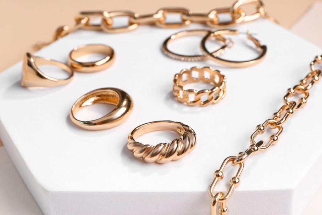 gold jewellery on a white decorative podium