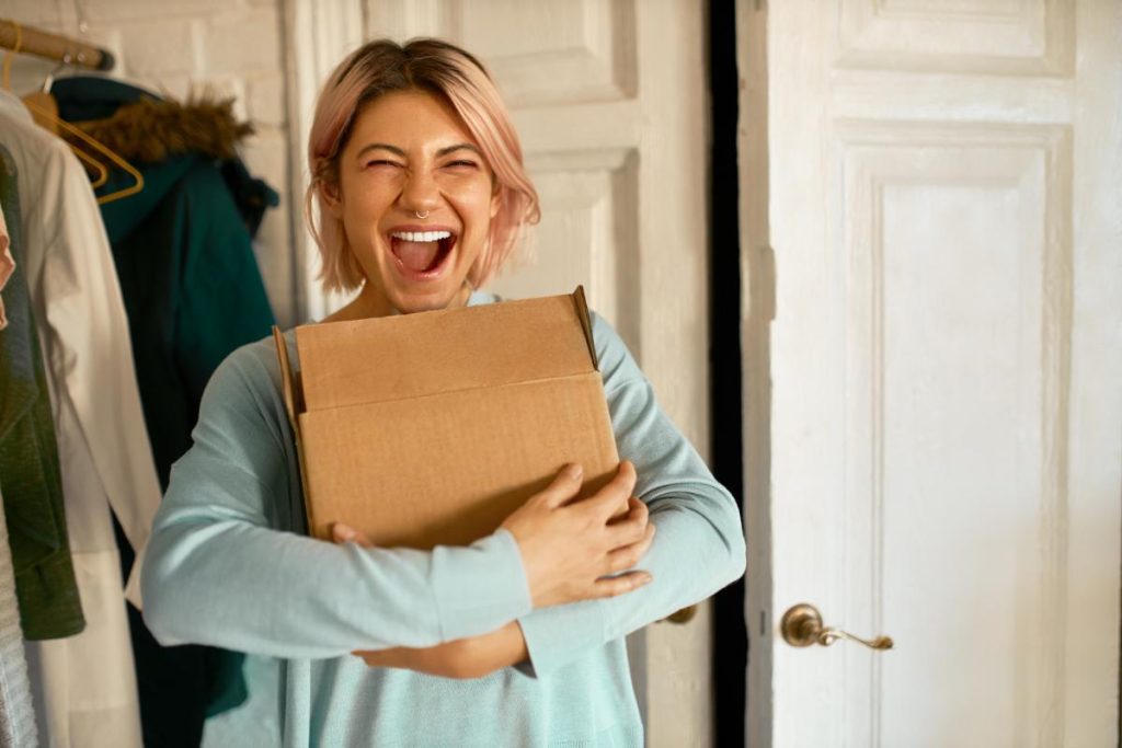 young woman hugging a box