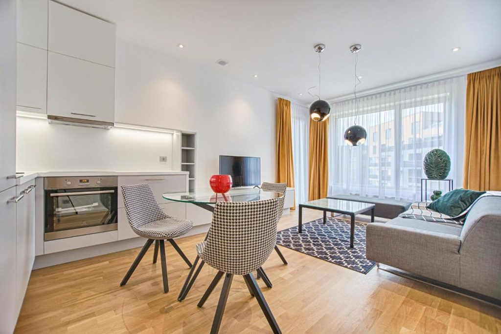 kitchen and living room with large windows and ceiling to floor curtains