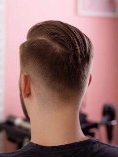 man after getting his hair cut at the salon - back view of hairstyle