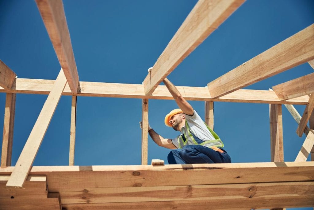 construction worker building a roof
