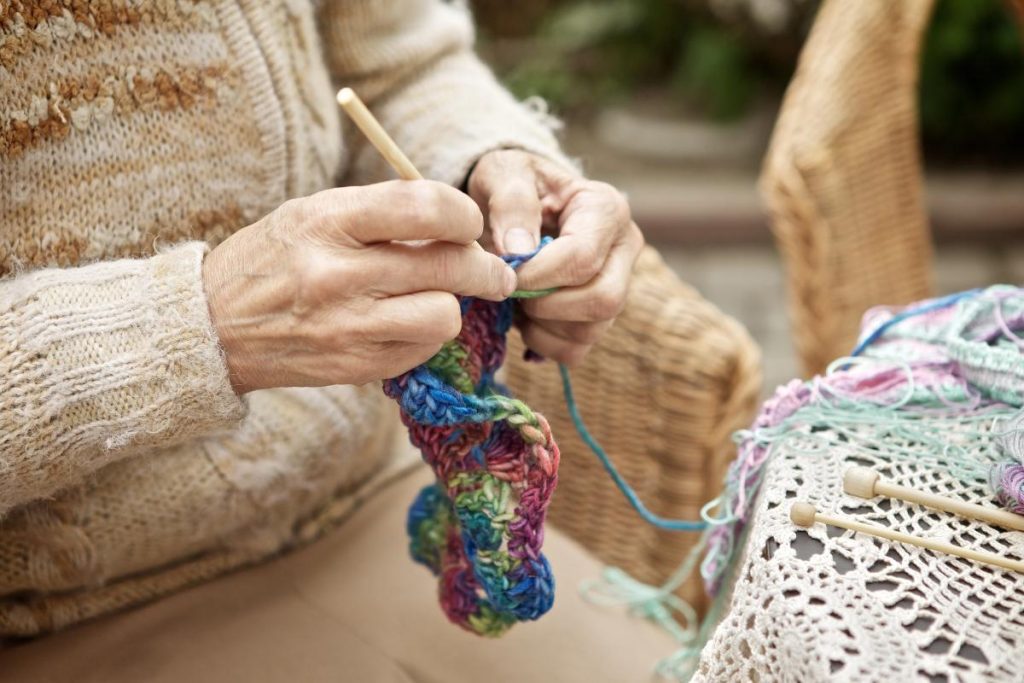 older woman's hands knitting