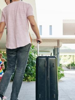 parents and daughter with luggage at airport
