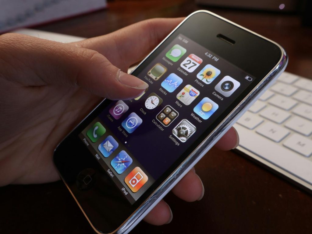 person holding an old iphone